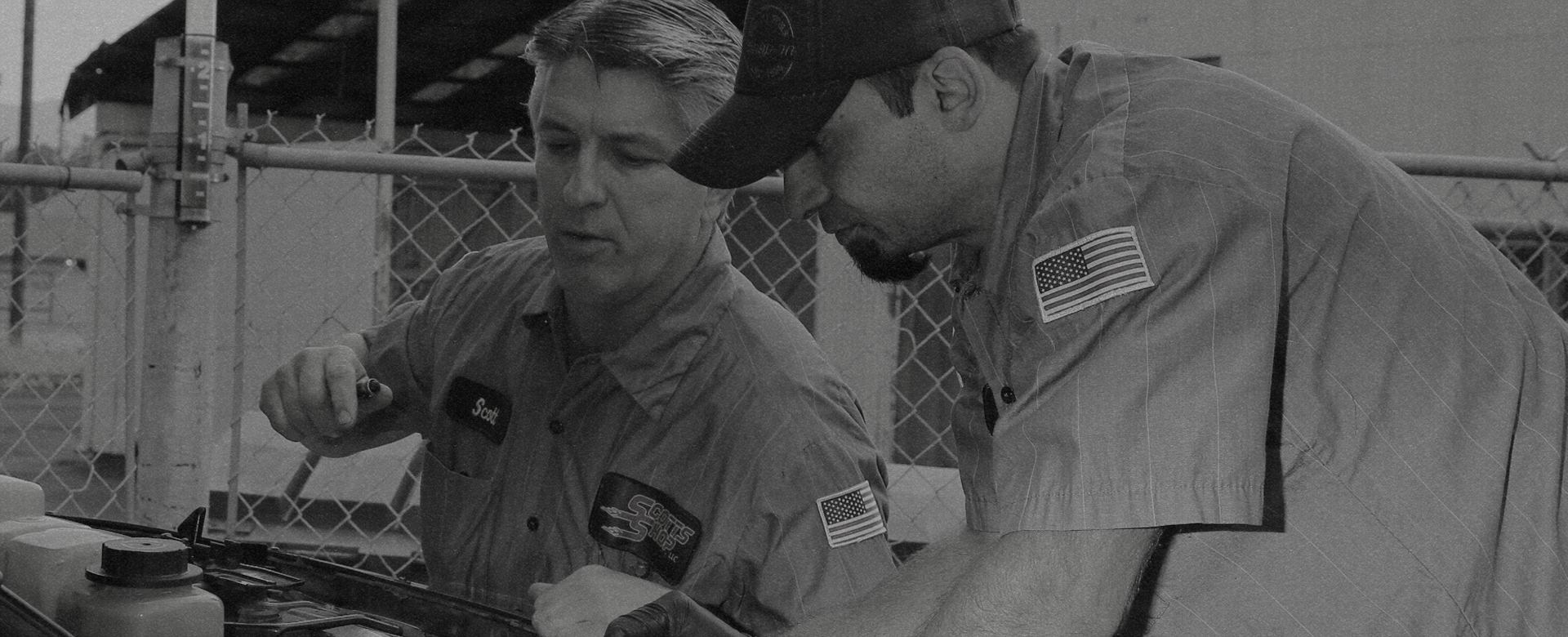 Scott, left, and a technician working under the hood